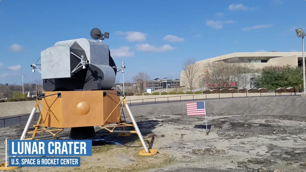 Lunar lander model and American flag at the Moon Crater display in January 2022.